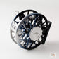 A close-up studio shot of a fly fishing reel, showing its black and blue anodized frame, silver spool, and a silver central cap with the 'Allee' brand logo.