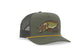 An olive green Bajio trucker hat with a black mesh back, featuring an embroidered northern pike fish on the front and a thin yellow rope along the brim.