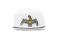 A white structured Bajio baseball cap featuring an embroidered brown pelican with outstretched wings on the front, and a black rope trim along the edge of the flat brim.